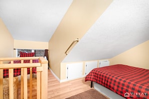 At the top of the stairs, you'll find a ladder leading up to the loft, where an additional queen bed and single bed await