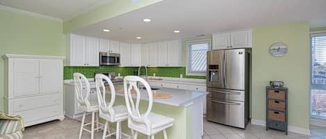 Kitchen featuring updated appliances and bright and white décor