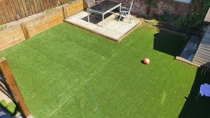 Nice all year round garden complete with two patio areas and artificial grass