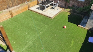 Nice all year round garden complete with two patio areas and artificial grass