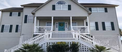 Front of House during the day.  3 story house.  Top 2 floors living area.