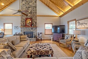 Lots of comfortable seating in the living room and a magnificent floor to ceiling  fireplace!