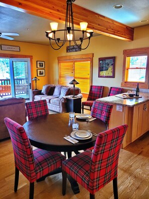 Dining room table has leaf to seat 6 plus 2 bar stools at the counter.