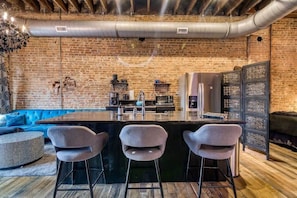 The original brick walls capture the downtown city vibes right in your very own loft!