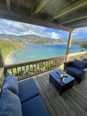 Covered porch with stunning views of private beach and Caribbean blue waters.