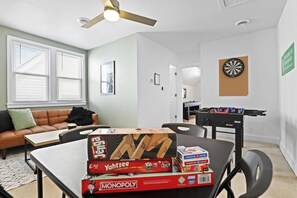 Game room on the 2nd level including darts, foosball, card table, board games, shuffleboard table, smart TV and sleeper futon.
