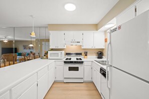 Fully Stocked Kitchen with Island Bar Seating