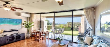 Living room with split AC, ceiling fan and smart TV