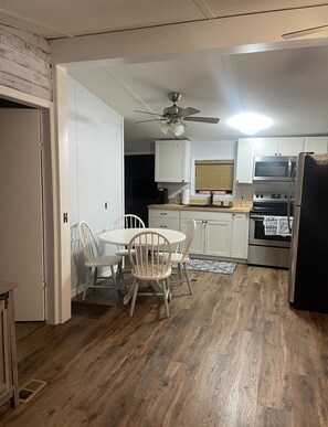 Kitchen,full size fridge,stove/oven, microwave, double sink.Small dining table.