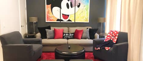 Whimsical Disney decor adorns this spacious living room