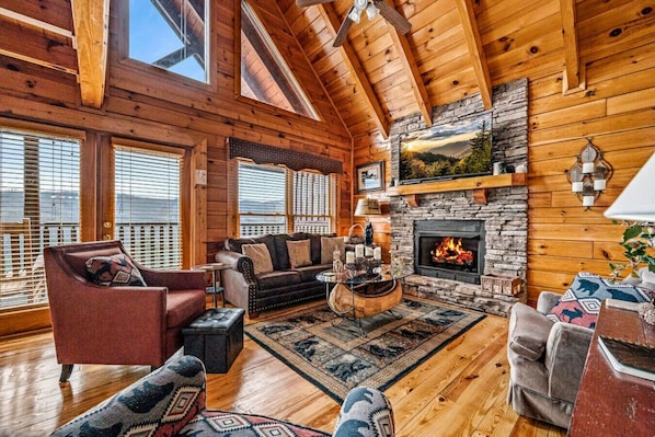 Beautiful living area with gas fireplace, comfortable furniture and large window that offer lots of natural light.