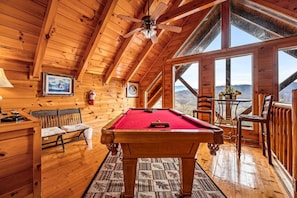 Recreation area upstairs with full-sized pool table, seating area and Smart TV.