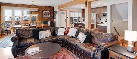 Winterset 8 *Pet Friendly* - a SkyRun Steamboat Property - Living Room- Plenty of room for friends and family on the luxurious leather couch. - Large U-shaped leather sofa, round coffeet table, oriental rug, and small end table