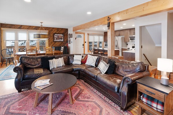 Winterset 8 *Pet Friendly* - a SkyRun Steamboat Property - Living Room- Plenty of room for friends and family on the luxurious leather couch. - Large U-shaped leather sofa, round coffeet table, oriental rug, and small end table