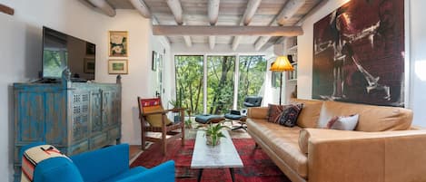 A living room with a couch and blue chairs.