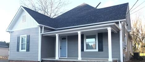 The entry for the apartment home has a full covered porch.