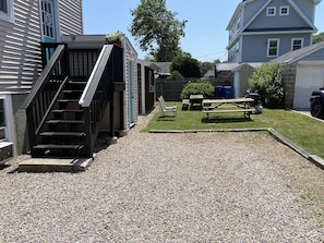 Gravel driveway holds 3 cars. Backyard picnic tables and grill