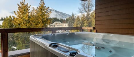The hot tub with a mountain view.