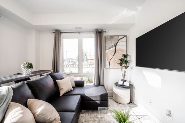 The cozy living room w/ a sectional sofa w/dbl pull-out bed perfect for a child.