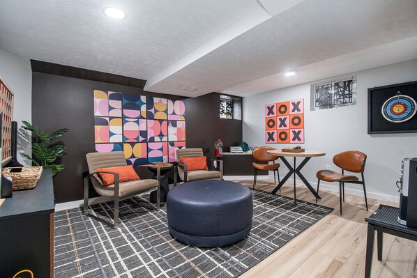 Modern basement hangout + 90s karaoke + game boards