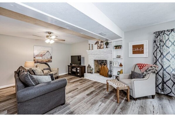 Living room with queen sofa bed and fireplace