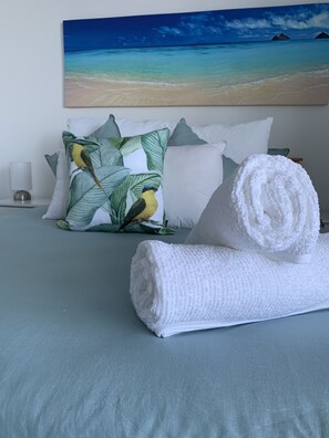 Beautiful light bedroom decor, clean, fresh towelling & bedding for guests
