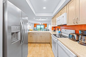 Modern kitchen with stainless steel appliances and an open layout.