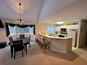 The dining area extending to the fully stocked. Offers a Keurig and coffee maker and cozy breakfast bar that seats 4.