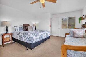 Master bedroom (upstairs) with California King bed, ceiling fan, ensuite bathroom, smart TV, private balcony