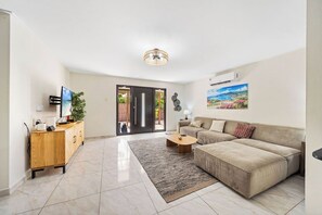 Sit back and unwind in the inviting living room, where you can enjoy a movie night or catch up on your favorite shows on the large TV.