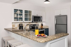 Full kitchen with silverware, plates, and glassware.