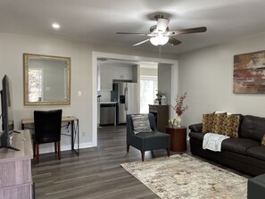 TV, desk and comfortable sofa and chairs in living room