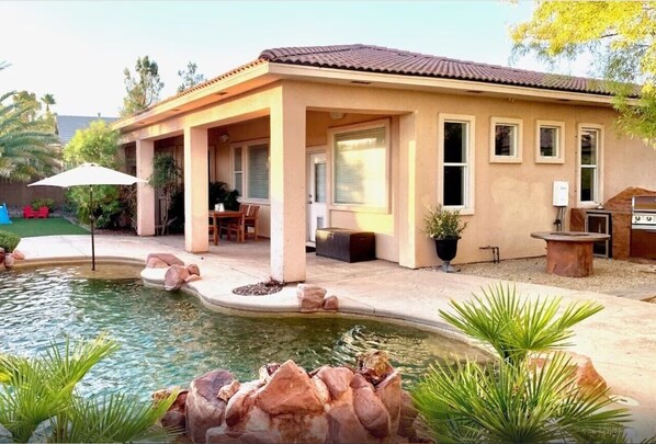 Backyard pool, bbq, and turf area