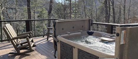 Enjoy a relaxing time in the hot tub.  Deck also has Weber gas grill.