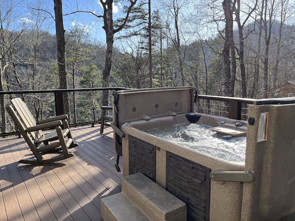 Enjoy a relaxing time in the hot tub.  Deck also has Weber gas grill.
