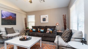 Living room with queen sofa bed sleeper and 55" Roku TV.  