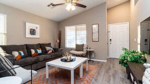 Living room with queen sofa bed sleeper and 55" Roku TV.  