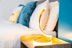 Stylish bedside lamp next to the double bed.