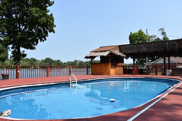 Pool and lakeside tiki bar with outdoor bathroom and kitchen just steps away.