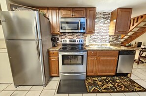 Full-sized stainless-steel appliances, electric cooktop, all dishware included!