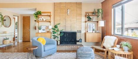 Spacious living room with mid century fireplace overlooking the mountains. 