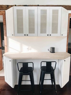 Eating/work nook in the kitchen. SONOS speaker on the countertop.