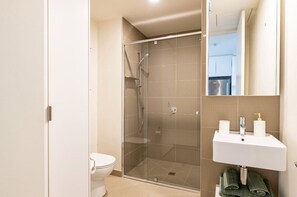 Large, modern bathroom with walk in shower and euro laundry. Supplies and towels