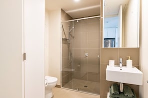 Large, modern bathroom with walk in shower and euro laundry. Supplies and towels