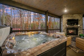 Hot Tub Oasis: Soak in serenity with forest views and a fireplace glow for ultimate relaxation!