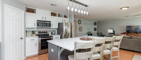 Fully equipped kitchen with stainless steel appliances and an open concept layout