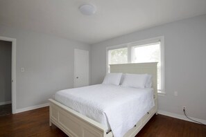 Queen sized bed with premium mattress and bed linens with storage.