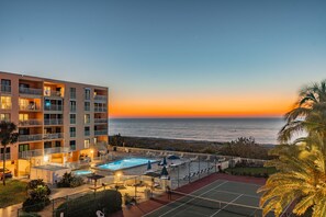 Sunset Views from the large balcony overlooking the pool, hot tub & tennis court