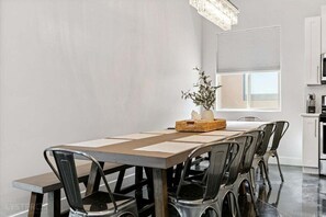 Enjoy meals in this beautiful dining area, highlighted by a large farmhouse table with seating for 12. The combination of natural wood and elegant details sets the stage for lively dinners and special celebrations.