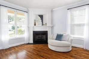 Enjoy a wood-burning by the window while reading a book on the loveseat.